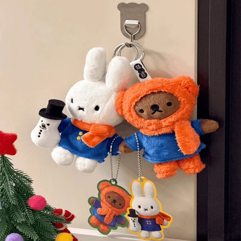 Seasonal plush character ornaments and bag charms displayed on a hook